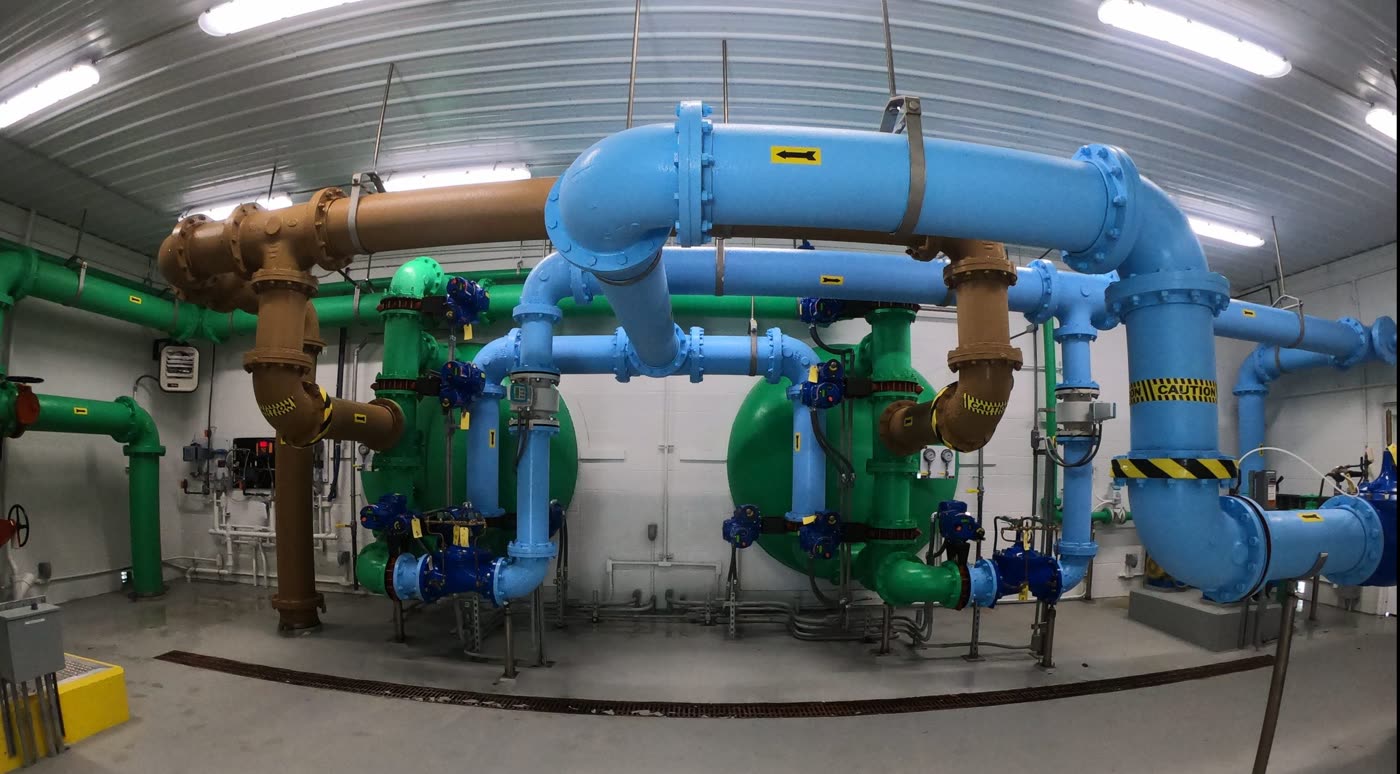 Blue and green process piping in the pump room of the Llangollen Water Treatment Plant.