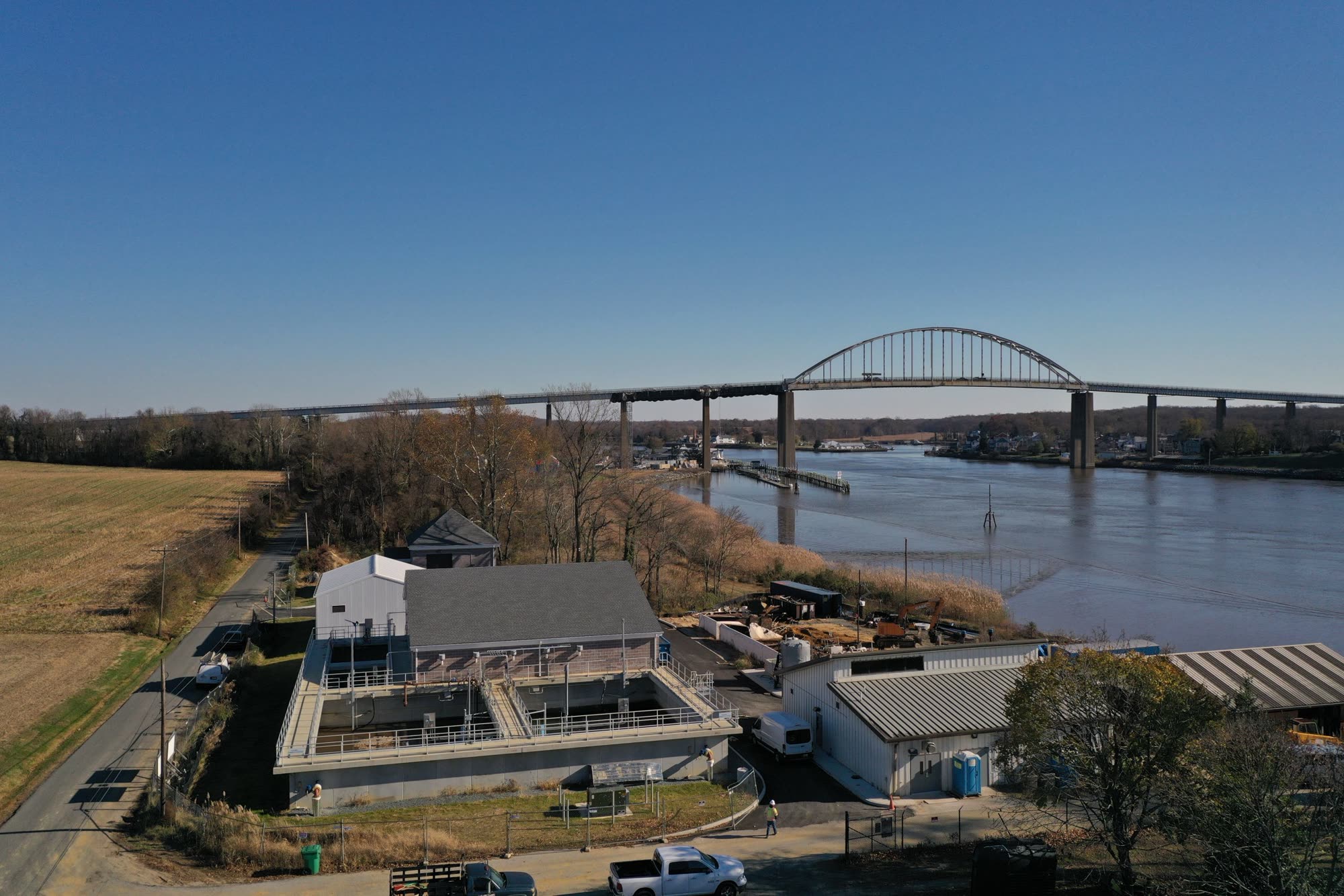 Aerial view of the Chesapeake City wastewater treatment plant beside the C&D Canal bridge.